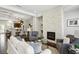 Open-concept living room featuring a stone fireplace and seamless flow to the kitchen at 709 Bismark Ne Rd, Atlanta, GA 30324