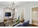 Well-lit office space with views to a bathroom and staircase, and modern light fixture at 709 Bismark Ne Rd, Atlanta, GA 30324