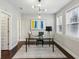 Stylish home office with a modern light fixture, decorative rug, and abstract artwork above the desk at 709 Bismark Ne Rd, Atlanta, GA 30324