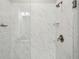 Beautiful shower features marble style tiles and bronze fixtures at 709 Bismark Ne Rd, Atlanta, GA 30324