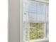Window with horizontal blinds let in natural light at 709 Bismark Ne Rd, Atlanta, GA 30324