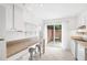 Efficient kitchen with white cabinetry, a breakfast bar, and access to a private patio at 3264 Henderson Mill Rd # C, Atlanta, GA 30341