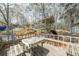 A spacious backyard with a wooden deck, a playground set, and a trampoline, ideal for outdoor activities at 4520 Jackybell Trl, Decatur, GA 30034