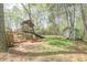 A spacious backyard with a playhouse and shed, perfect for ' outdoor activities and storage at 4520 Jackybell Trl, Decatur, GA 30034