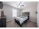 Comfortable bedroom with a rustic wooden headboard, ceiling fan, and dresser at 4520 Jackybell Trl, Decatur, GA 30034