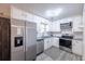 Modern kitchen featuring stainless steel appliances, white cabinetry, and granite countertops at 4520 Jackybell Trl, Decatur, GA 30034