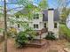 Back exterior view showcases a multi-tiered deck and lush landscaping, perfect for outdoor relaxation and entertainment at 4829 Thicket Nw Path, Acworth, GA 30102