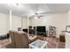 Basement den area with neutral carpet, a ceiling fan, a TV, and comfortable seating for relaxation and entertainment at 4829 Thicket Nw Path, Acworth, GA 30102