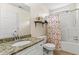 Bright bathroom features a granite countertop, a shower and tub combination, and a colorful seahorse shower curtain at 4829 Thicket Nw Path, Acworth, GA 30102