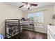 Cozy bedroom with a loft bed, large window, and a view of the backyard and neighborhood at 4829 Thicket Nw Path, Acworth, GA 30102