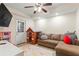 Versatile bonus room featuring tile flooring, a couch, a TV, a playhouse, and an exterior door for easy access at 4829 Thicket Nw Path, Acworth, GA 30102