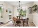Bright breakfast nook featuring a round wooden table, neutral walls, and a sunlit window with plants at 4829 Thicket Nw Path, Acworth, GA 30102