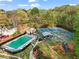 Aerial view of community amenities, including a swimming pool, lounge chairs, tennis courts, a playground, and mature trees at 4829 Thicket Nw Path, Acworth, GA 30102