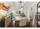 Bright dining room featuring hardwood floors, neutral walls, a modern chandelier, and bay windows at 4829 Thicket Nw Path, Acworth, GA 30102