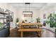 Bright dining room featuring hardwood floors, neutral walls, and modern chandelier with a large wooden table at 4829 Thicket Nw Path, Acworth, GA 30102