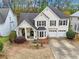 Aerial view of a charming two-story home, showcasing a well-manicured lawn and mature trees at 4829 Thicket Nw Path, Acworth, GA 30102