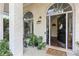 Inviting front porch with a decorated door and stylish decor, plants, and large arched windows at 4829 Thicket Nw Path, Acworth, GA 30102