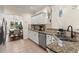 The kitchen has stainless steel appliances, granite countertops and backyard view from kitchen sink at 4829 Thicket Nw Path, Acworth, GA 30102