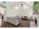 Bright living room with hardwood floors, high ceilings, a fireplace, and a staircase to the second floor at 4829 Thicket Nw Path, Acworth, GA 30102