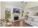 Bright living room with hardwood floors, a fireplace, and an open floor plan with views to the kitchen at 4829 Thicket Nw Path, Acworth, GA 30102