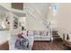 Bright living room featuring hardwood floors, high ceilings, a fireplace, and a staircase to the second floor at 4829 Thicket Nw Path, Acworth, GA 30102