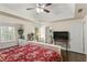 Spacious main bedroom boasting a tray ceiling, a ceiling fan, and large windows with a view of the backyard at 4829 Thicket Nw Path, Acworth, GA 30102