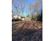 Expansive backyard with mature trees and a flat grassy area, ideal for outdoor activities at 4985 Doby Ln, Austell, GA 30106