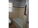 A classic bathroom featuring a tub with ceramic tile walls, and a window for natural light at 4985 Doby Ln, Austell, GA 30106