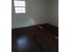 Cozy bedroom with hardwood floors, a window letting in sunlight, and neutral wall color at 4985 Doby Ln, Austell, GA 30106