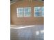 Bright and airy living area featuring tiled floors and multiple windows for natural light at 4985 Doby Ln, Austell, GA 30106