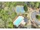 Aerial view showcasing community amenities including a pool, tennis courts, and lush landscaping at 2830 Willow Hill Ct, Cumming, GA 30040