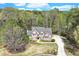 Stunning aerial view of a brick home with lush trees, and a private driveway at 2830 Willow Hill Ct, Cumming, GA 30040