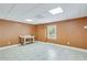Finished basement with a painted brick wall and a finished window at 2830 Willow Hill Ct, Cumming, GA 30040