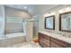 Bright bathroom featuring a walk-in shower, soaking tub and double vanity with stone counters and modern fixtures at 2830 Willow Hill Ct, Cumming, GA 30040