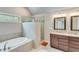 Spacious bathroom with a soaking tub, glass-enclosed shower, double vanity with granite countertops, and modern fixtures at 2830 Willow Hill Ct, Cumming, GA 30040