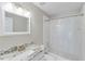 Well-lit bathroom featuring a granite countertop, framed mirror, and a shower with a clear shower curtain at 2830 Willow Hill Ct, Cumming, GA 30040