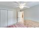 Bedroom with a ceiling fan, closet with folding doors, and a door to another room creating a seamless transition at 2830 Willow Hill Ct, Cumming, GA 30040