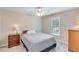 Cozy bedroom with a ceiling fan, a window bringing in natural light, and neutral-colored walls and carpet at 2830 Willow Hill Ct, Cumming, GA 30040