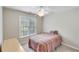 Inviting bedroom with a window, ceiling fan, and soft lighting, showcasing a relaxing and comfortable space at 2830 Willow Hill Ct, Cumming, GA 30040