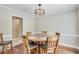 Charming dining room with hardwood floors and stylish lighting fixture at 2830 Willow Hill Ct, Cumming, GA 30040