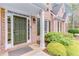 Beautiful front door with dark green paint and trim, surrounded by manicured landscaping at 2830 Willow Hill Ct, Cumming, GA 30040