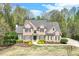 Charming brick home with manicured lawn, lush landscaping, and a welcoming entrance at 2830 Willow Hill Ct, Cumming, GA 30040