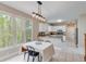 Bright kitchen with granite countertops and adjacent breakfast nook with wooded view at 2830 Willow Hill Ct, Cumming, GA 30040