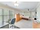 Expansive main bedroom featuring a sitting area, desk, large windows, and a door to a private balcony at 2830 Willow Hill Ct, Cumming, GA 30040