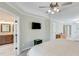 Spacious main bedroom features a ceiling fan, ensuite bath, and mounted TV at 2830 Willow Hill Ct, Cumming, GA 30040
