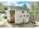 Rear exterior of home shows multiple decks and a walk out basement, surrounded by mature trees at 2830 Willow Hill Ct, Cumming, GA 30040
