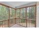 Relaxing screened porch with wood trim offers a serene view of the surrounding trees and backyard at 2830 Willow Hill Ct, Cumming, GA 30040