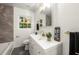 Stylish bathroom featuring a modern vanity, elegant fixtures, and a tub with a marble accent wall at 2905 Dale Creek Drive Nw, Atlanta, GA 30318