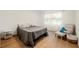 Comfortable bedroom with wood floors, large window, and stylish furniture at 2905 Dale Creek Drive Nw, Atlanta, GA 30318