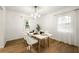 Dining area featuring wood floors, a modern light fixture, and white table with seating for four at 2905 Dale Creek Drive Nw, Atlanta, GA 30318